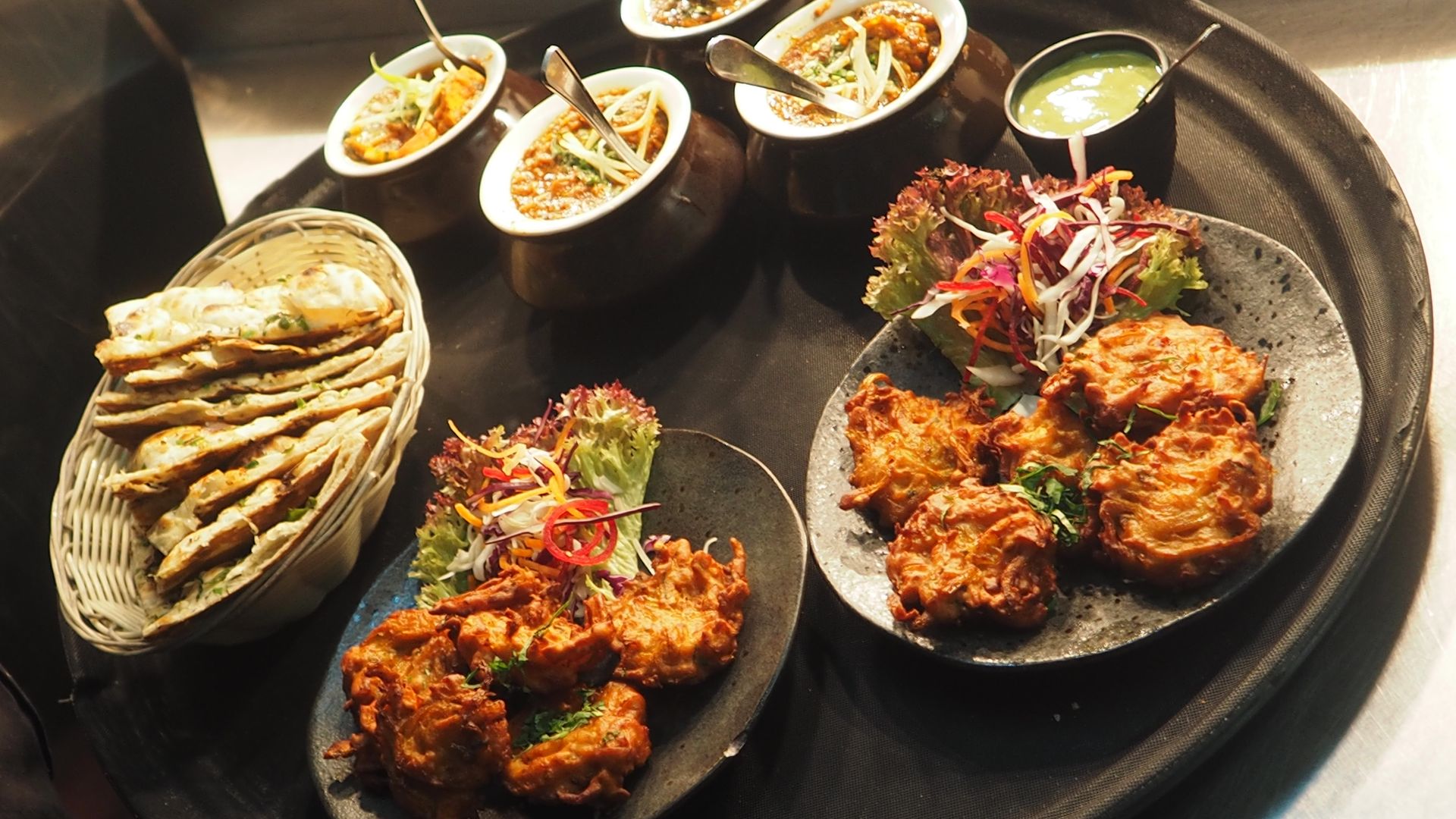 Authentic Indian catering spread with vibrant curries, rice and tandoori dishes
