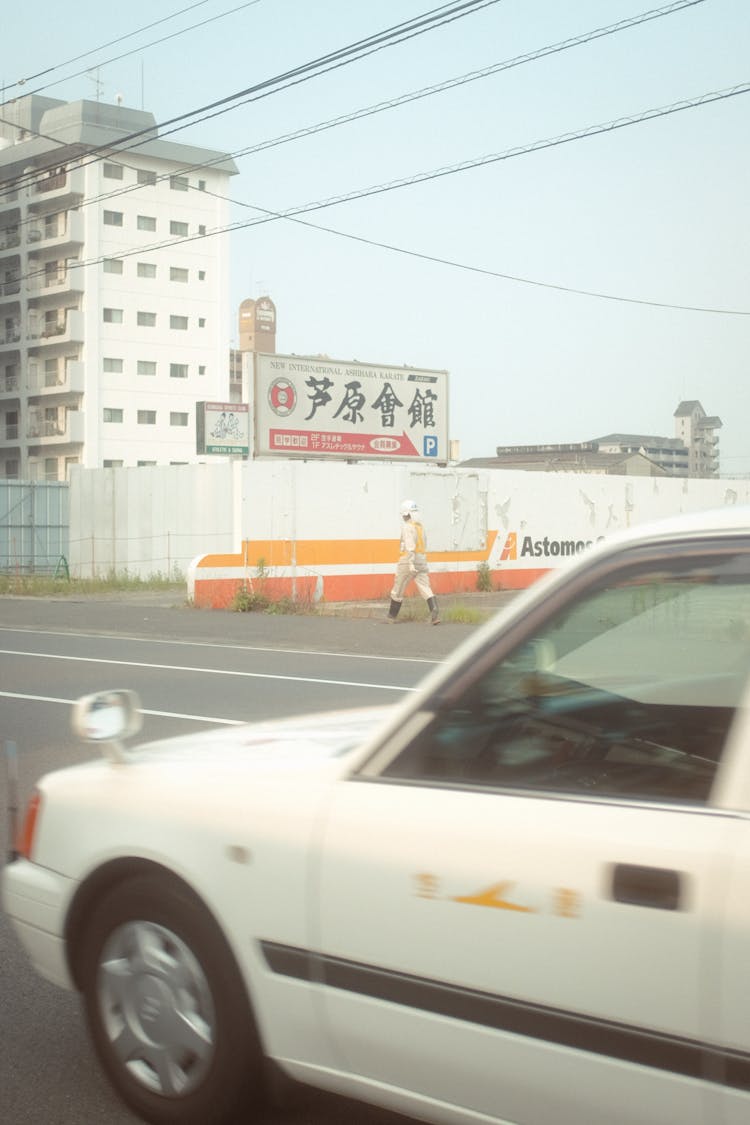 City Road With White Car And Chinese Script