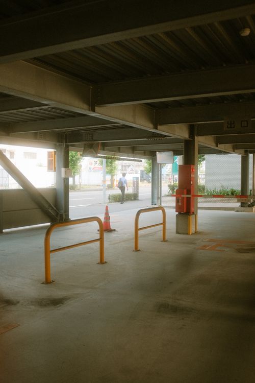 Free Empty urban parking area with metal beams and soft lighting, suitable for space-related themes. Stock Photo