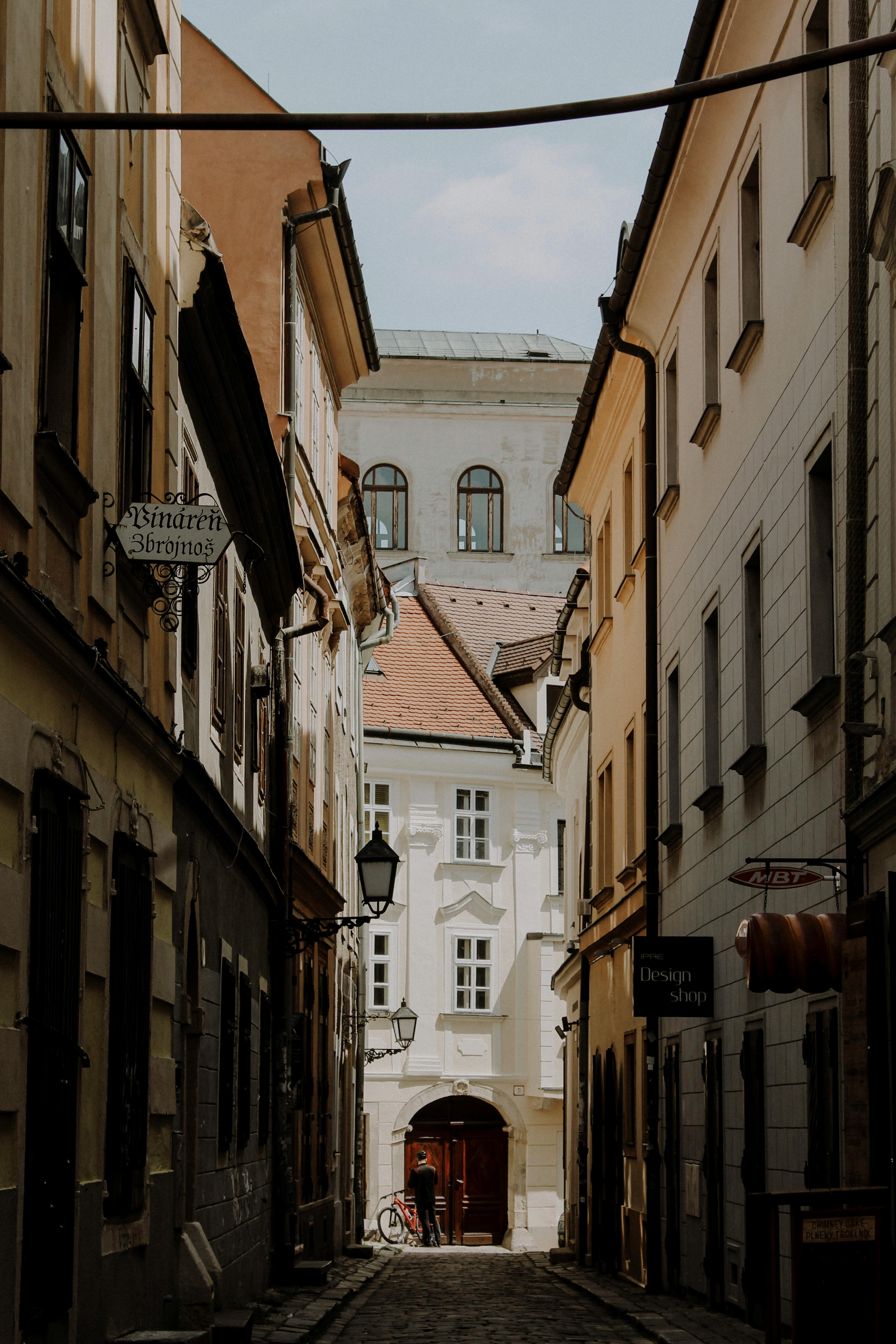 European alleyway showcasing historic architecture and street details on a sunny day.