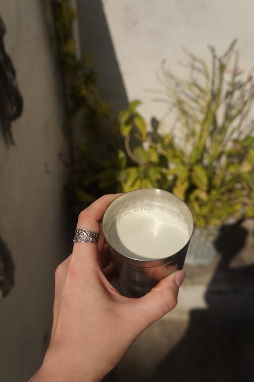 Cup of Milk in Woman Hand