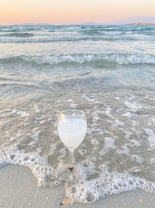 Clear Wine Glass on Beach Shore