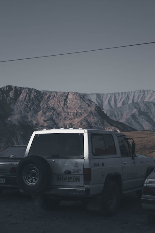 Vehicles Parked Near Mountains