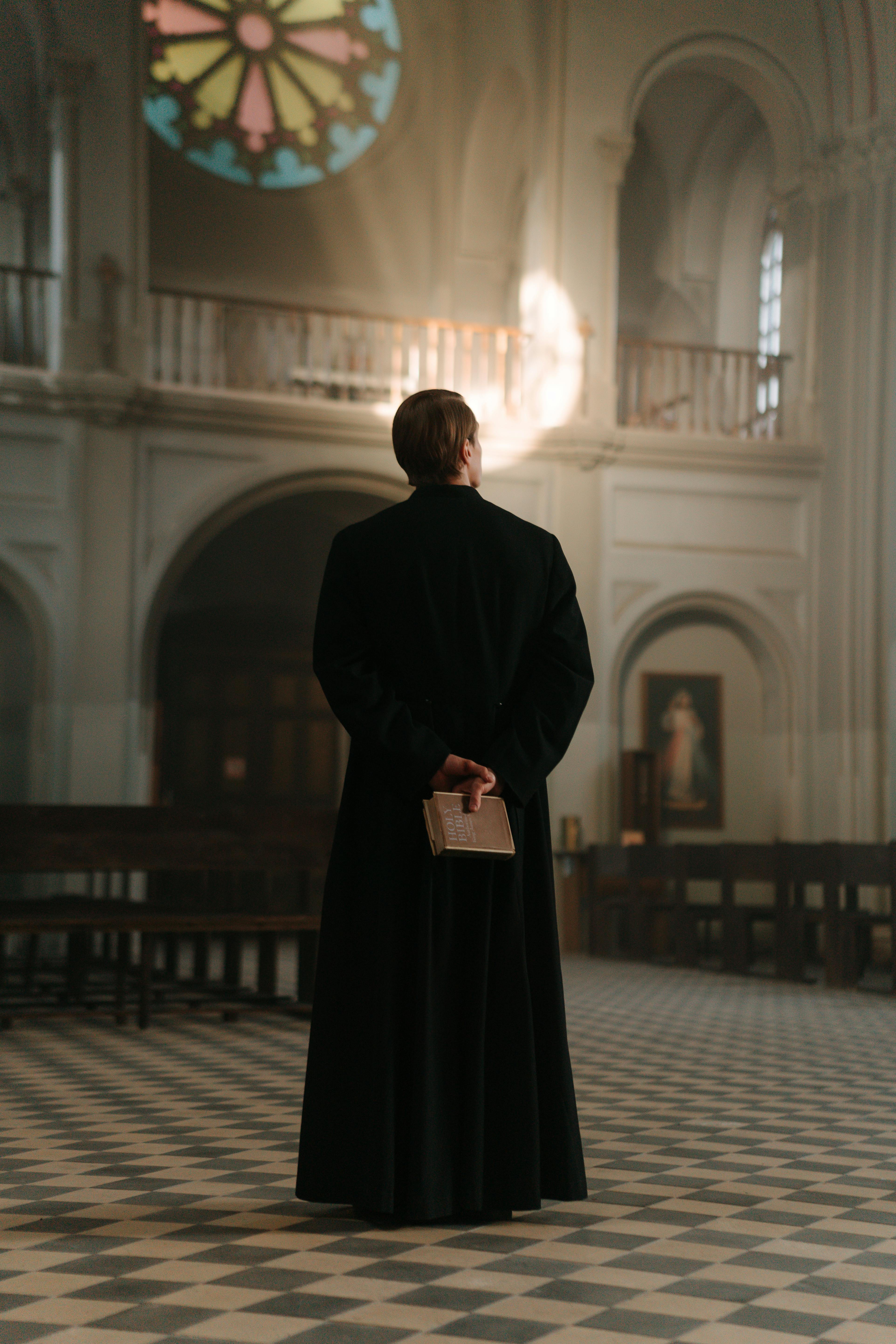 Free Backview of Priest in Black Cassock  Stock Photo