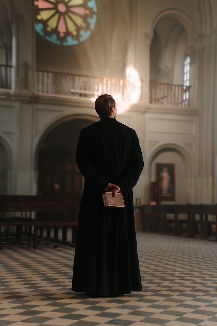 Backview Of Priest In Black Cassock 