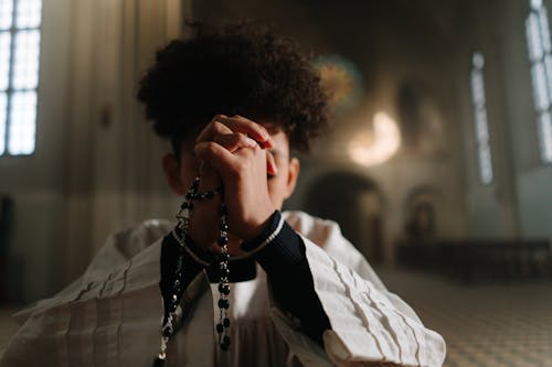 A Close-Up Shot of a Boy Praying