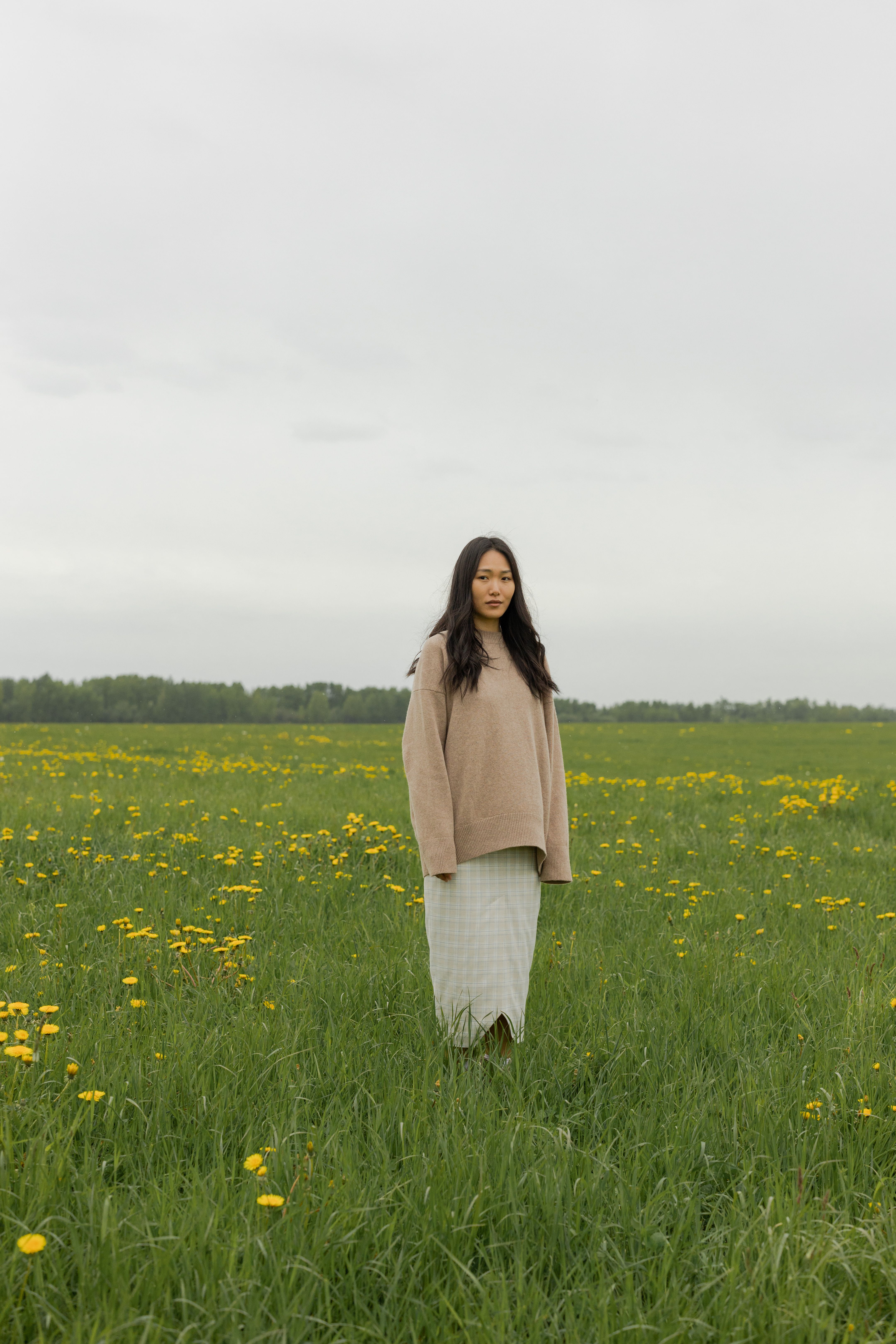 Woman in Brown Coat Standing on Green Grass Field · Free Stock Photo