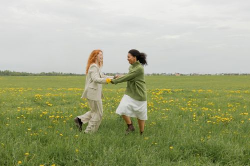 Women Running on a Field while Holding Hands · Free Stock Photo
