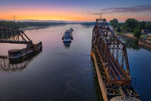 Railroad Bridge over Body of Water during Sunset