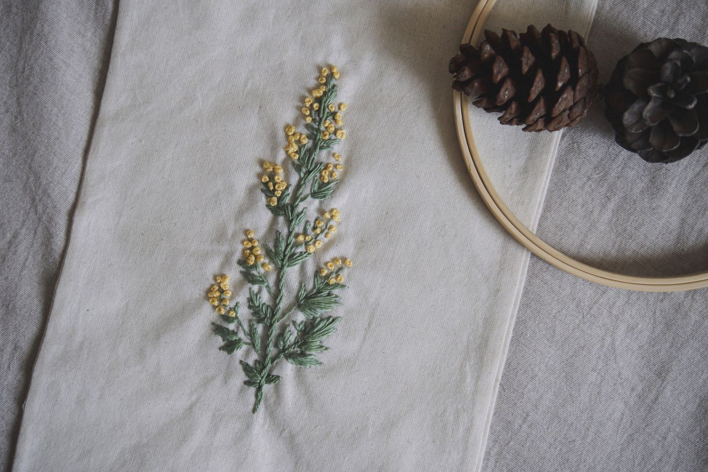Floral embroidery worked across a pale textile