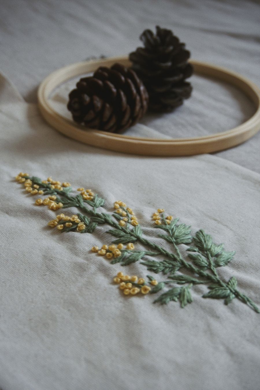 Mimosa sprig on linen