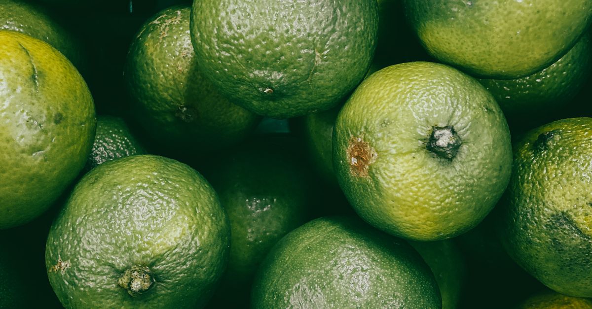 Green Lemon Fruit on White Surface · Free Stock Photo