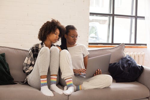 Woman in White Sweater Sitting Beside Woman in White Sweater