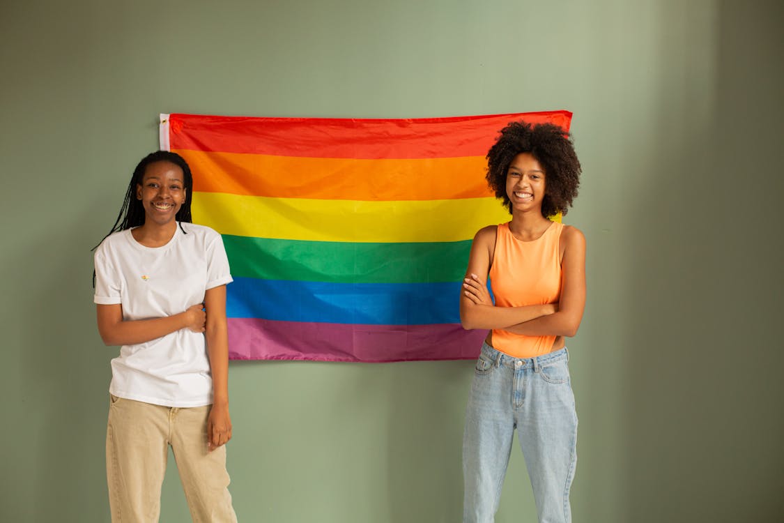 Free Women Standing beside Pride Flag Stock Photo