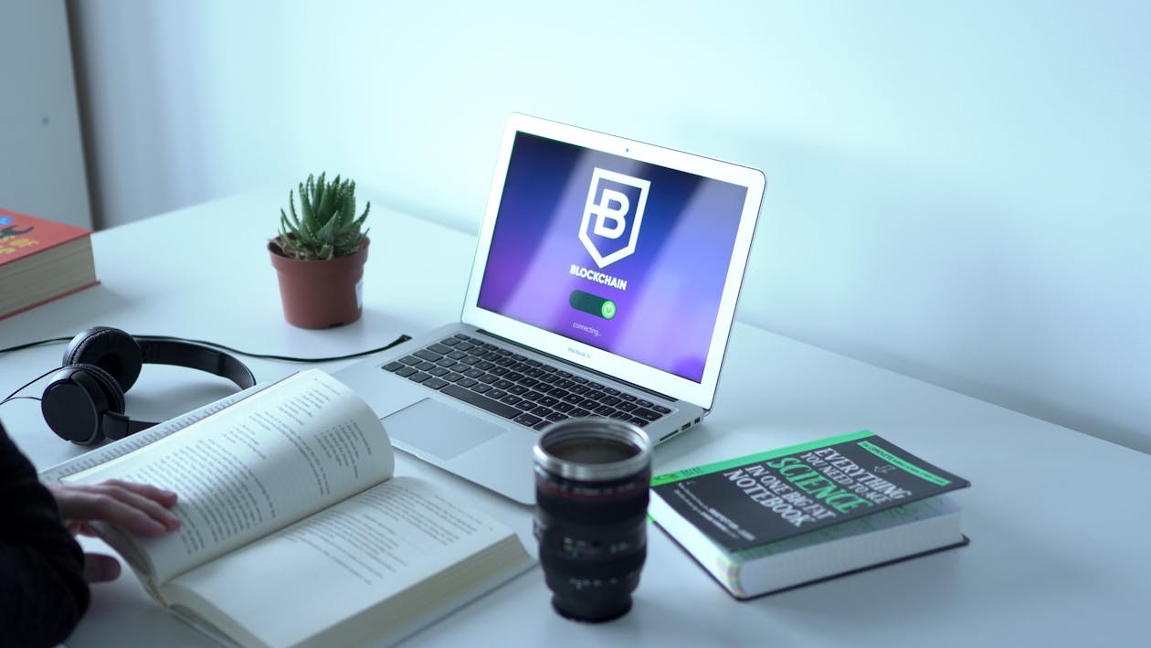 Free A Laptop and Books on a Table Stock Photo