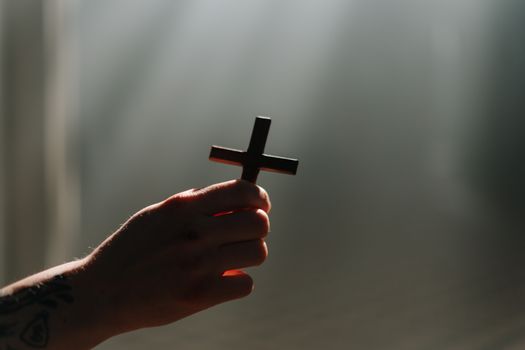 A Person Holding a Cross