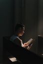 Man in White Tank Top Reading Book