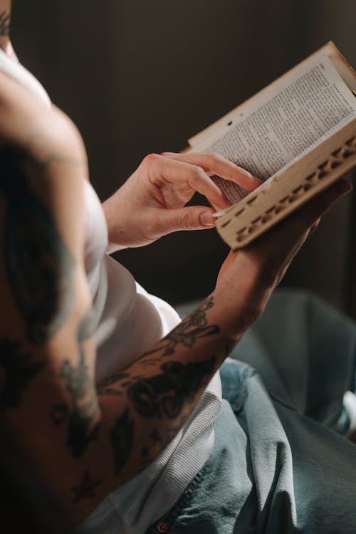 Free Close-Up Shot of a Person Reading a Bible Stock Photo