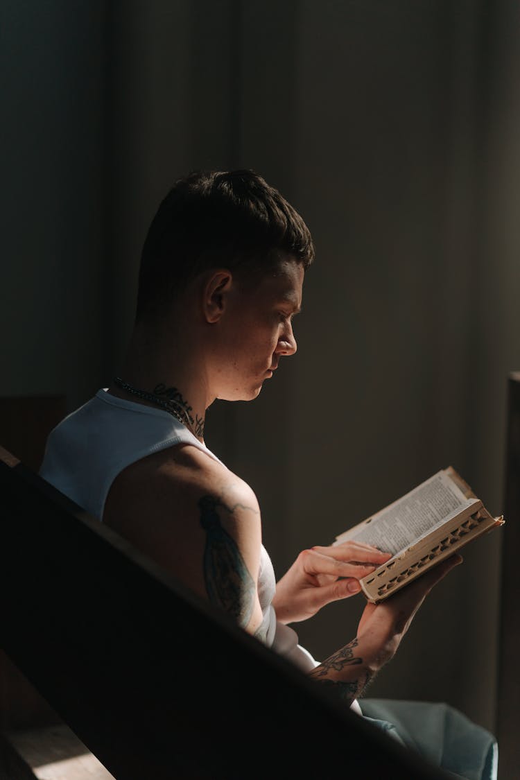 A Man Reading A Bible