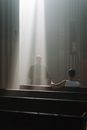 A Priest Standing in Front of a Man Sitting on a Pew
