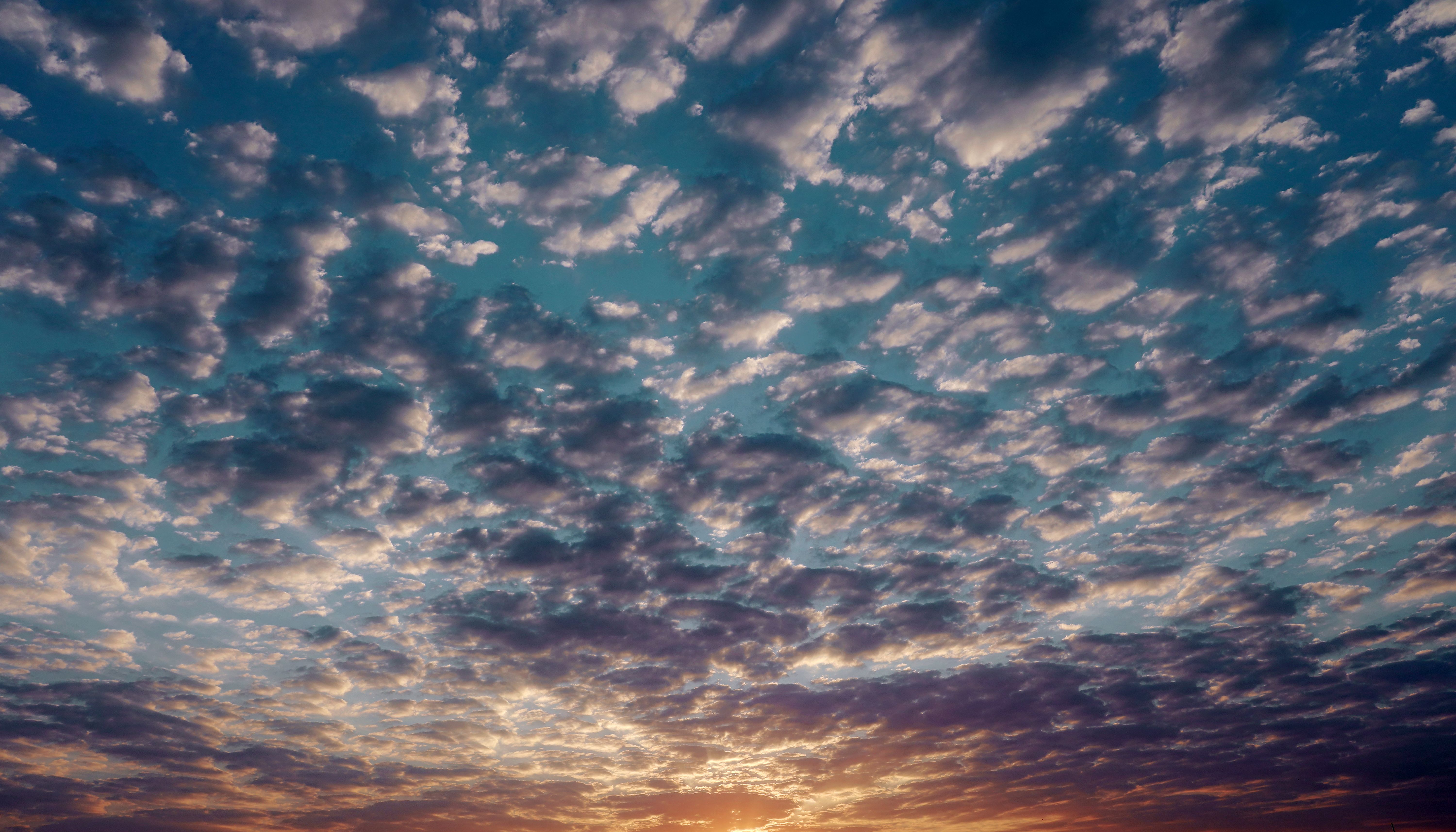 Stunning view of a cloudy sky at sunset in Mehsana, India, captured beautifully. | Indian Village Development