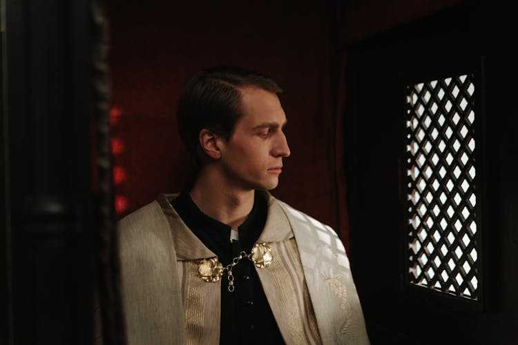 A Male Priest In A Confessional