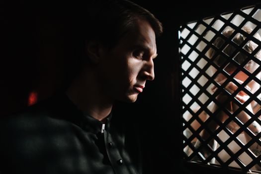 A Priest Listening to the Person Confessing