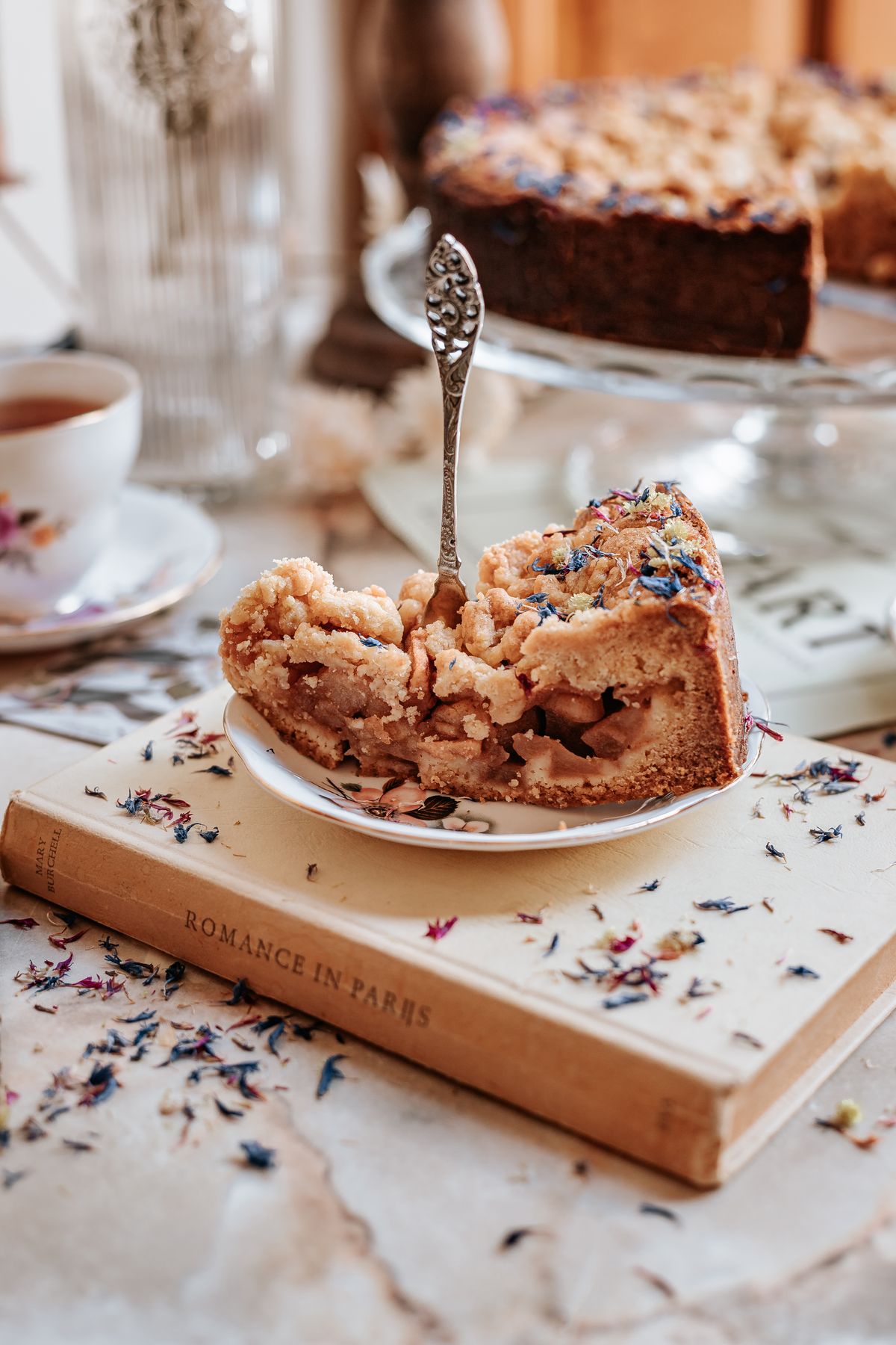 A slice of apple crumble pie on a plate
