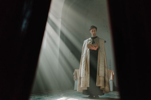 A priest reading in a church with dramatic sun beams highlighting his presence, conveying a sense of solemnity.
