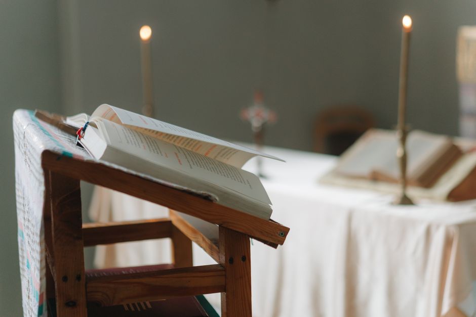 Open Bible with a candle symbolizing hope in the darkness - christian grief support Open Bible with a candle symbolizing hope in the darkness - christian grief support