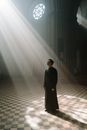 Man in Black Cassock Standing in the Cathedral