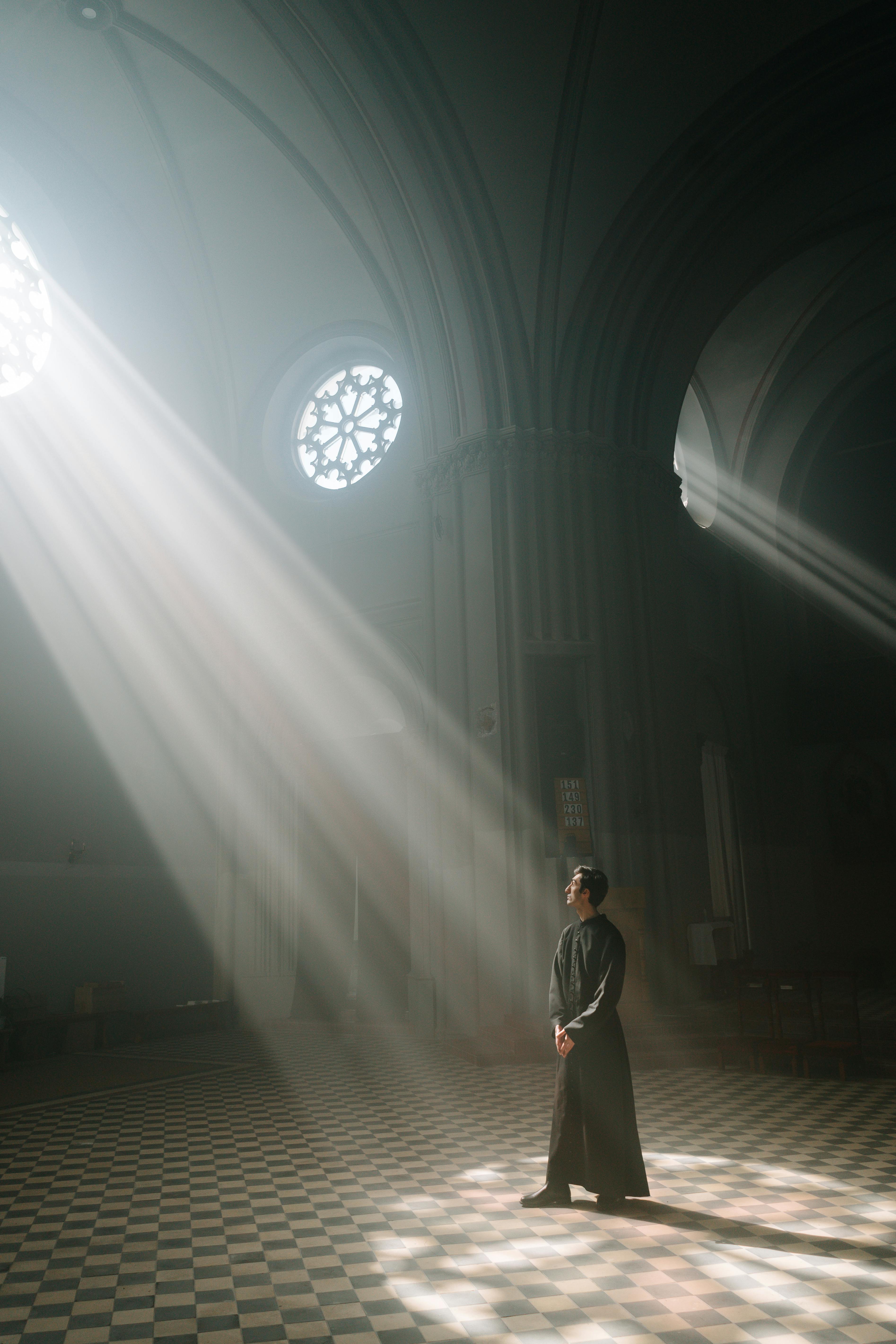 sunbeams over priest at church