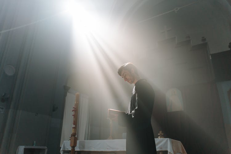 Priest In Cassock Reading Bible