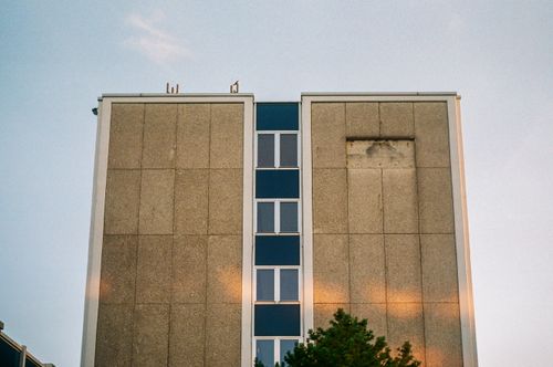 Free Simple concrete building facade against a twilight sky with subtle reflections. Stock Photo