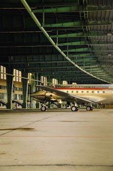 A vintage aircraft inside a hangar in Berlin, showcasing historical aviation design.