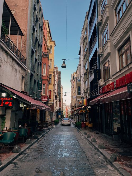 Free Discover a quaint cobblestone street in Beyoğlu, Istanbul lined with colorful buildings and bustling cafes. Stock Photo