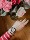 A Person Wearing Silver Round Analog Watch