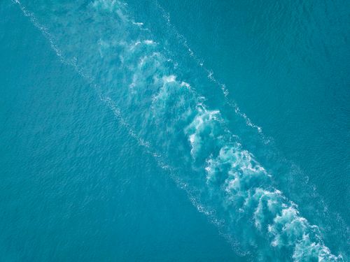 Free Explore the serenity of ocean waves captured from above in vivid blue hues. Stock Photo