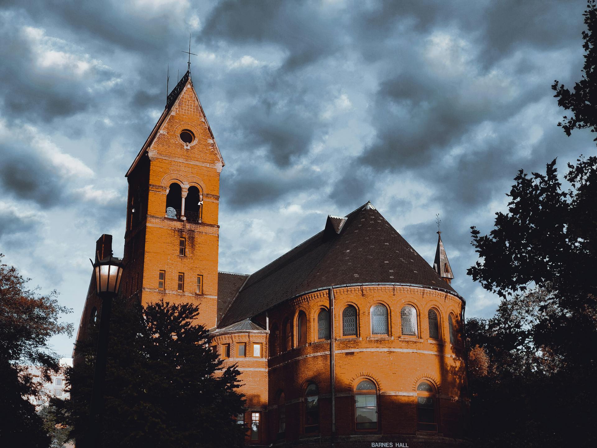 Barnes Hall in Ithaca, NY with its distinct architecture against a moody cloudy sky.