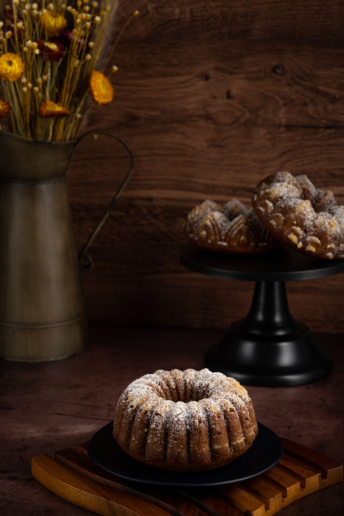 Bundt cakes dusted with powdered sugar on a table