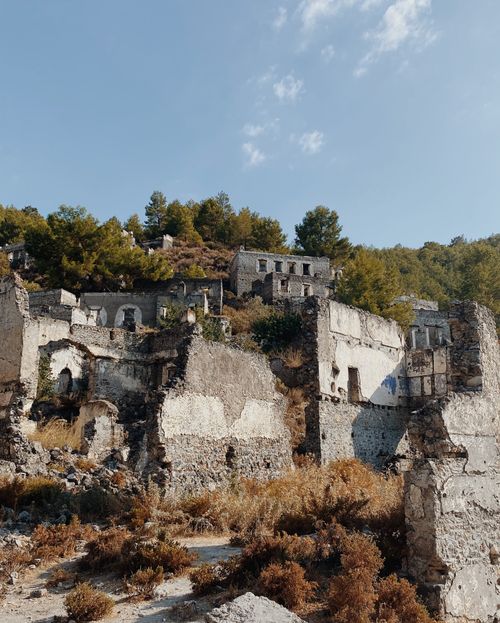 Free Explore ancient stone ruins surrounded by lush greenery under a clear blue sky. Stock Photo