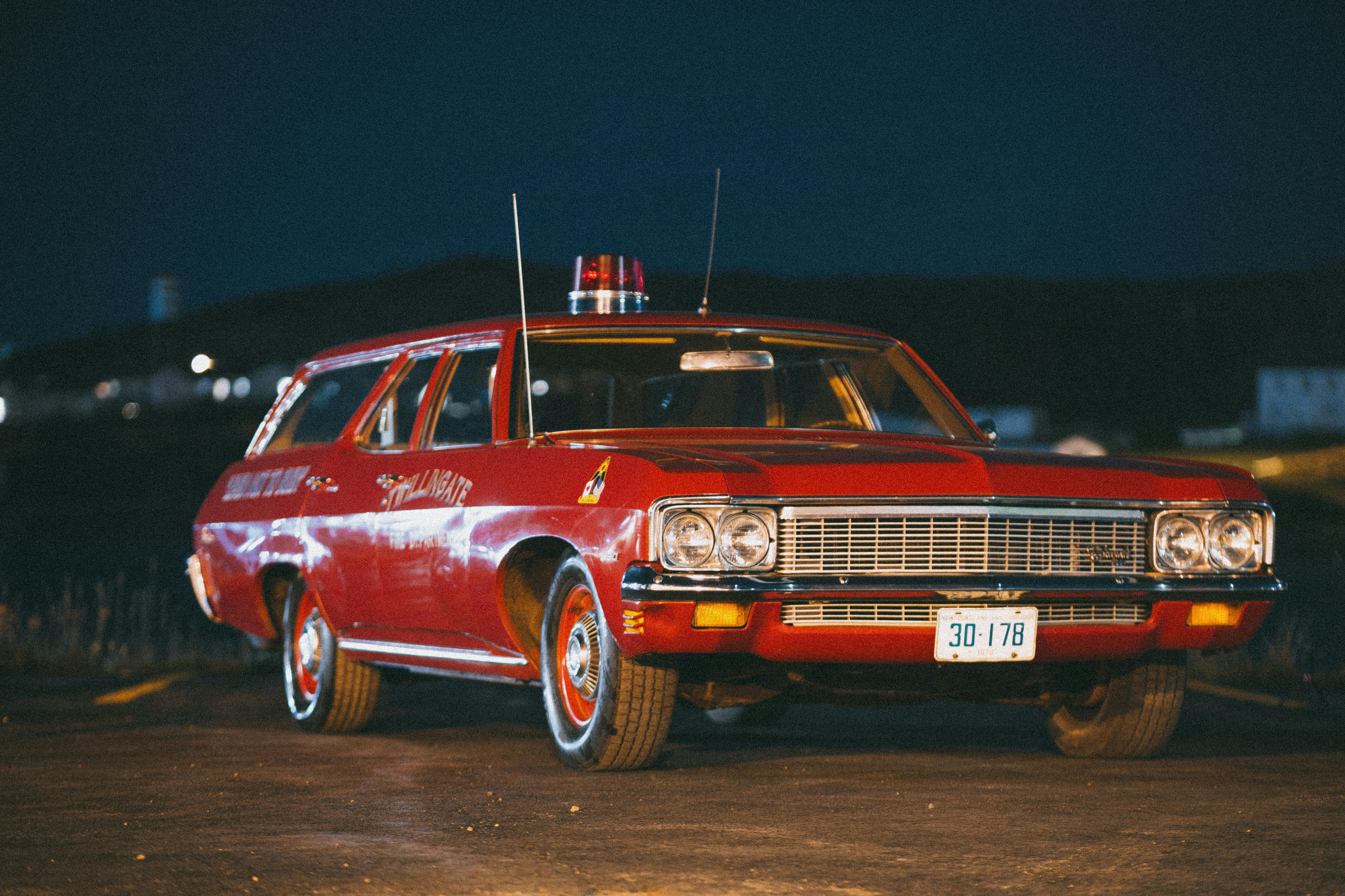 A Vintage Car Parked on the Street at Night · Free Stock Photo