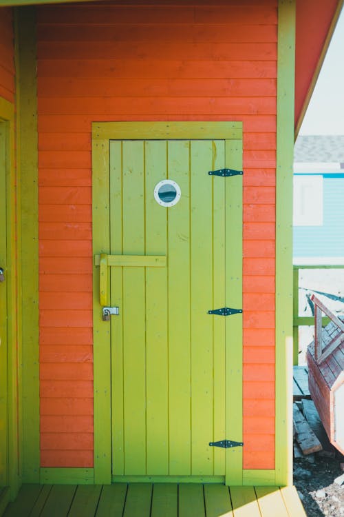 Green Wooden Door on Orange Wall