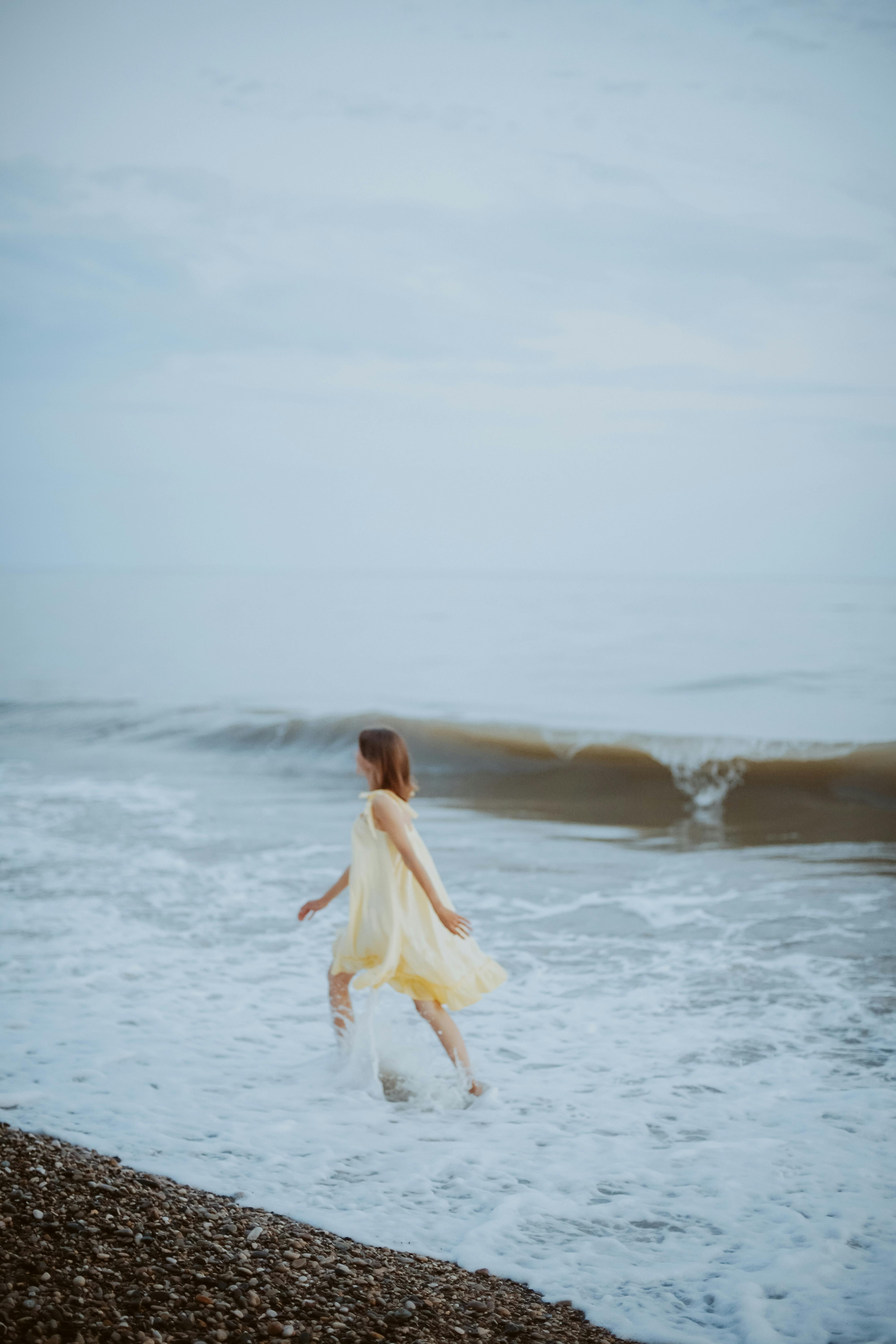 Woman Walking on Seashore · Free Stock Photo