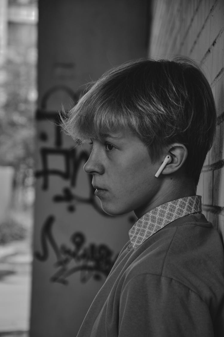 Monochrome Photo Of Young Man Using Airpods 