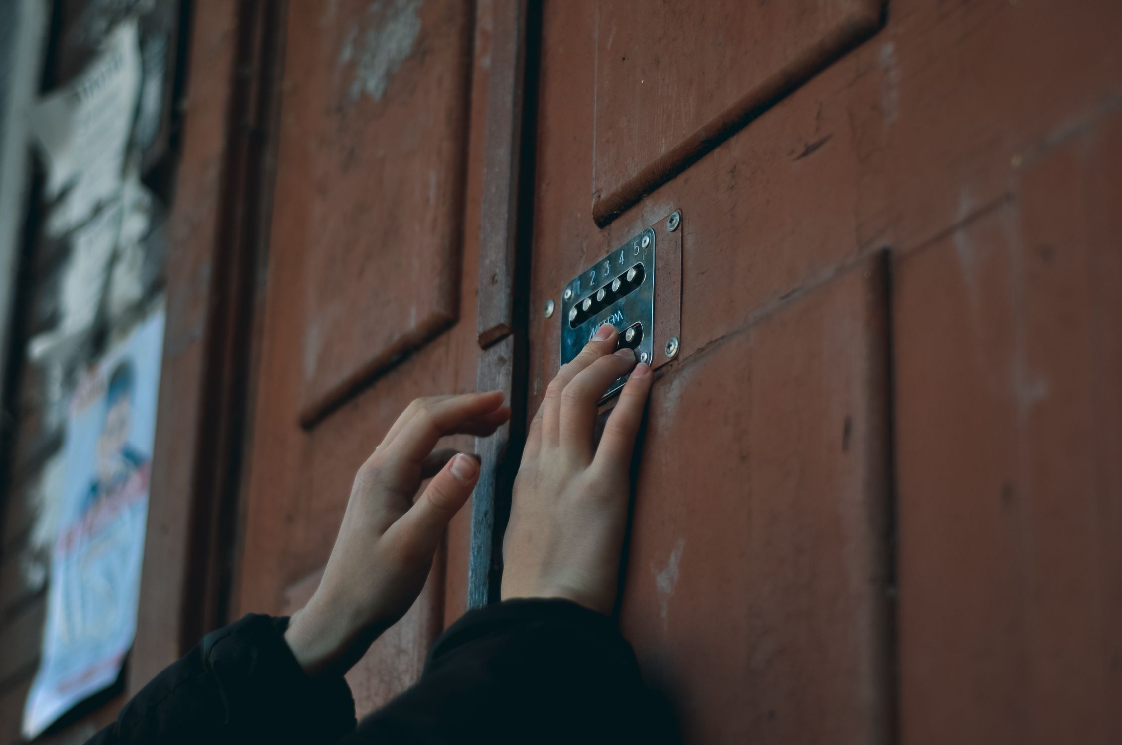 Person entering a code to open a door Person entering code to open a door