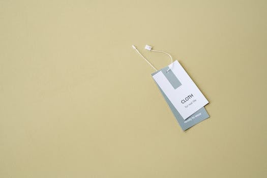 A stylish clothing label on a muted background offers ample copy space.