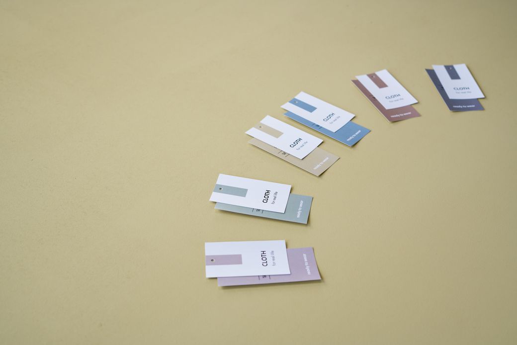 Fabric price labels fanned out on an olive backdrop, photo by Ron Lach on Pexels