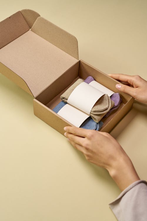 Person Holding Brown Cardboard Box