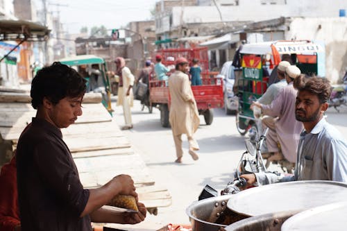 Free A Man Selling Food on the Street Stock Photo